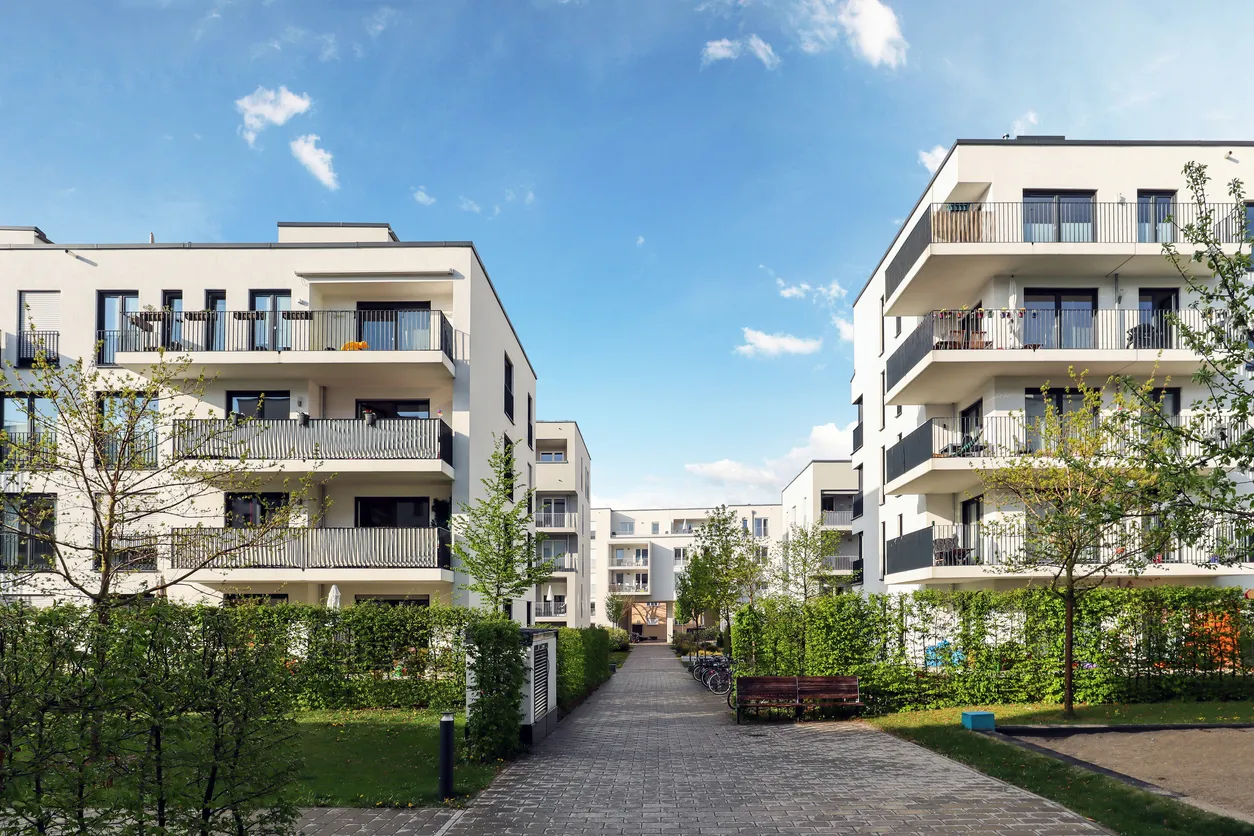 Stadtbild eines Wohngebietes mit modernen Mehrfamilienhäusern von gooltex